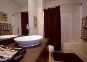 Thumbnail 31 of 31 - a bathroom with a sink and a shower and a toilet  at Aventura at Richmond, St. Peters, MO